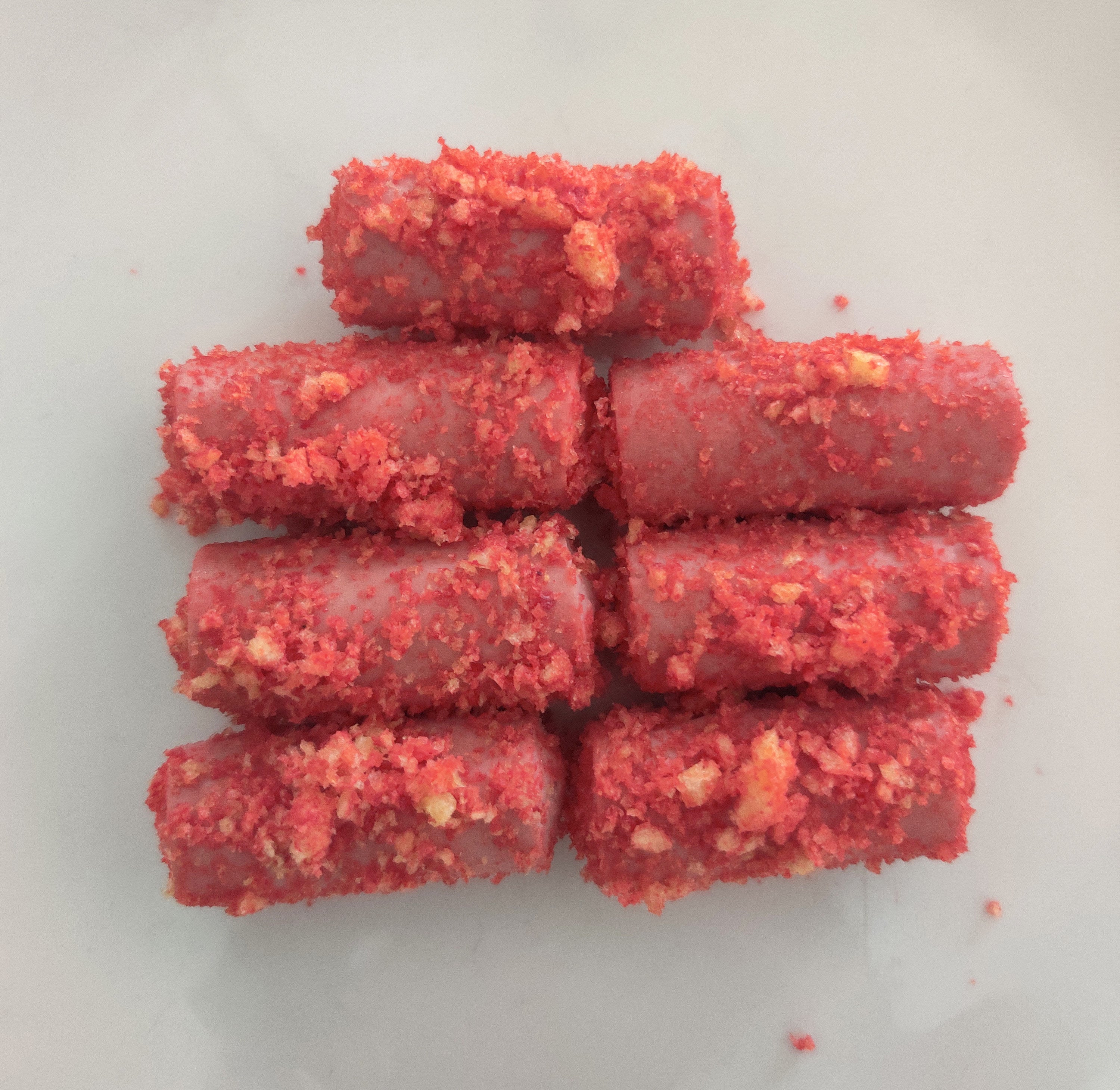The finished and somewhat unsightly product: seven Vienna sausages covered in bright-red crushed Cheetos