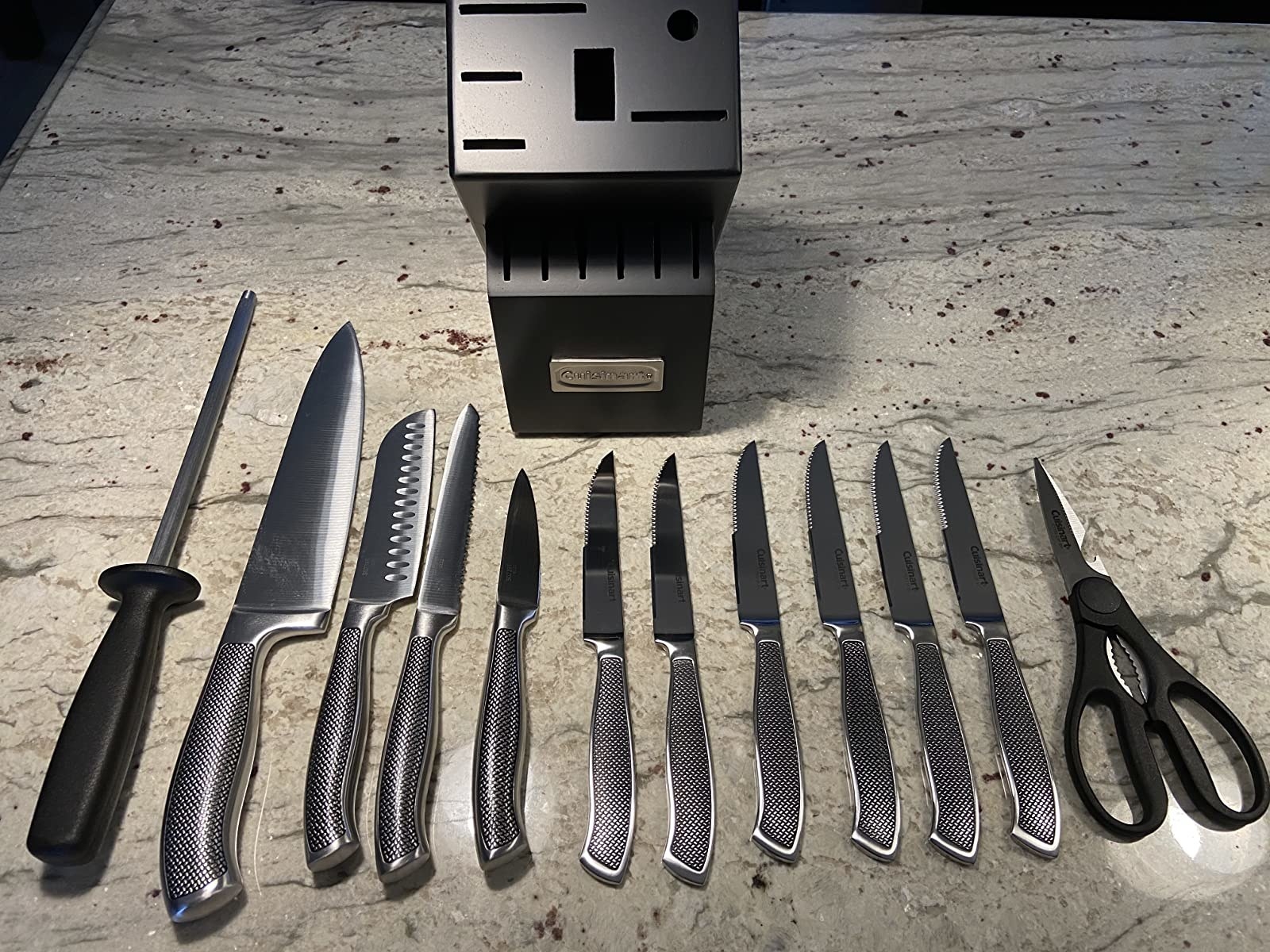 reviewer image of the 13 piece cuisinart graphix knife set laid out on a kitchen counter