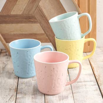 Several mugs in pastel colors 