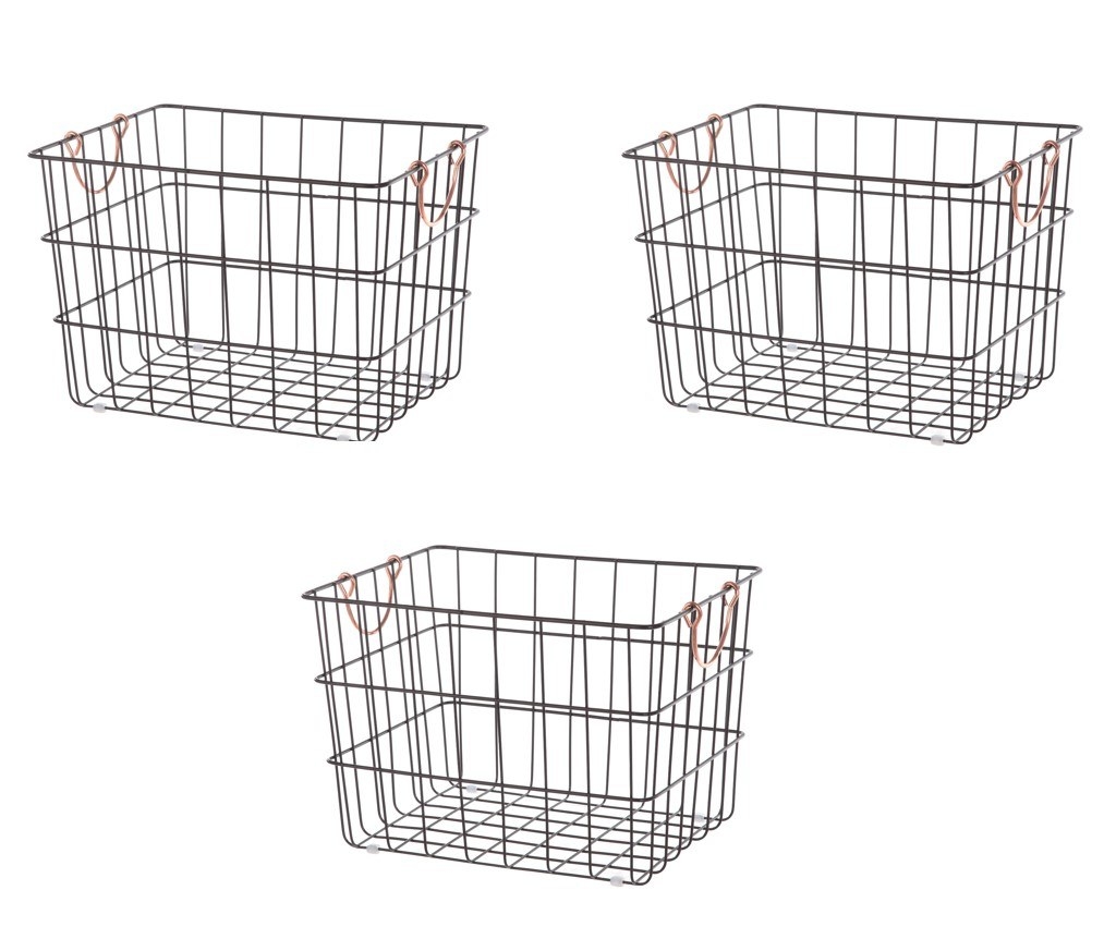 a photo of three black metal wire baskets with brass handles