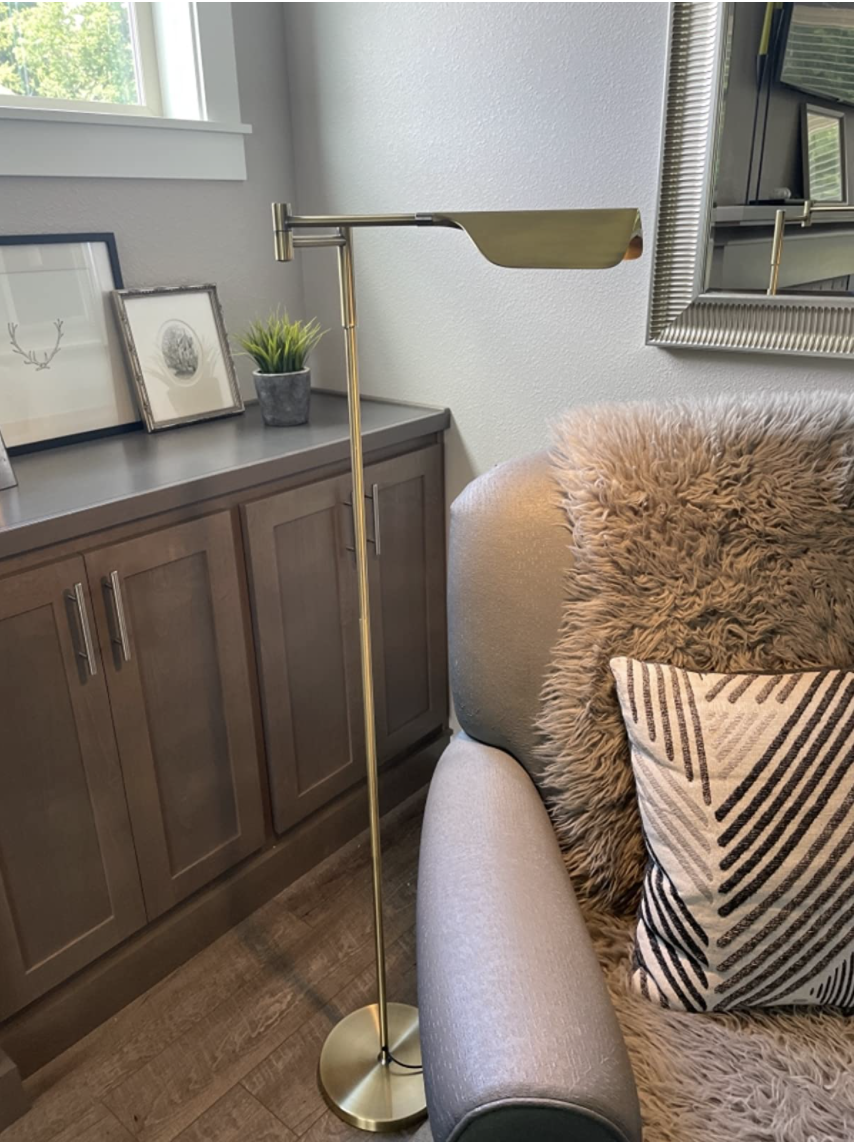 Reviewer&#x27;s lamp hangs over a reading chair