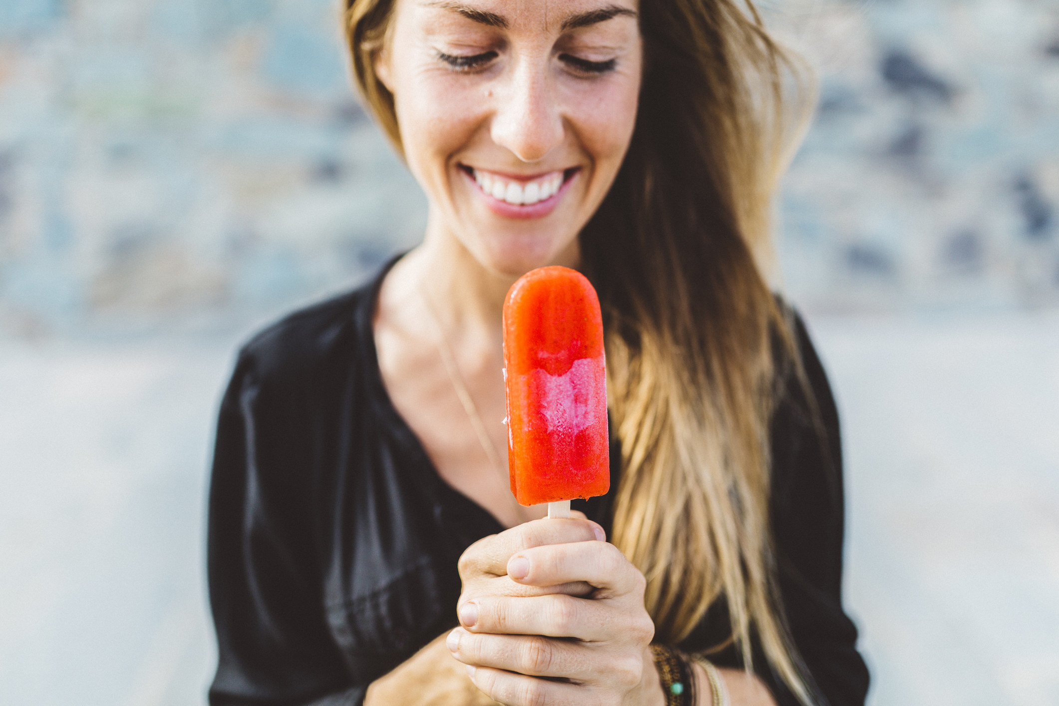 a person holding a bright popsicle