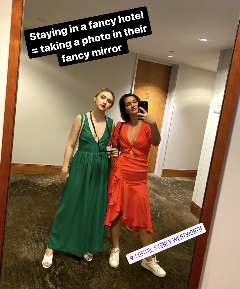 BuzzFeed Editors taking mirror selfie in hotel lobby mirror