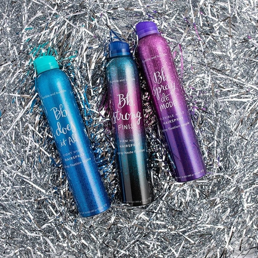 three hairsprays including the spray de mode on the right