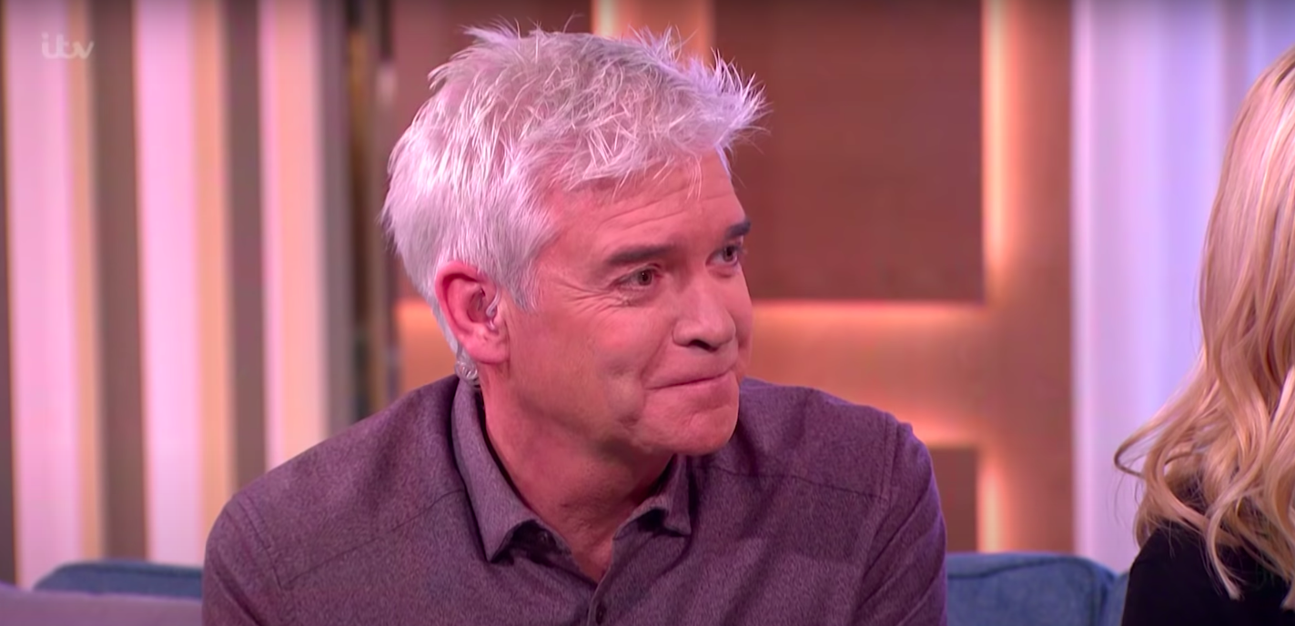 Phillip Schofield holding in a laugh