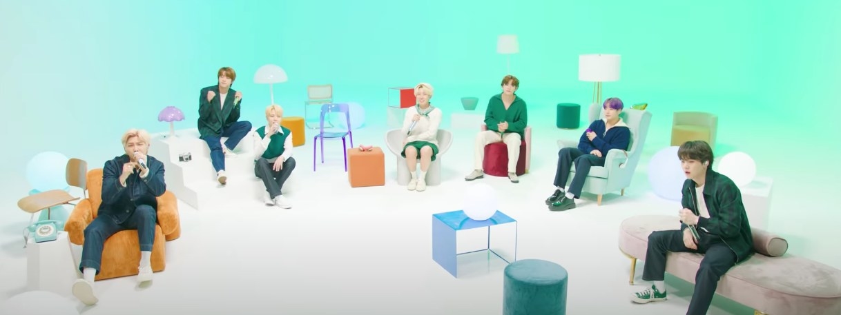 BTS sit on colorful furniture performing &quot;Look Here&quot;