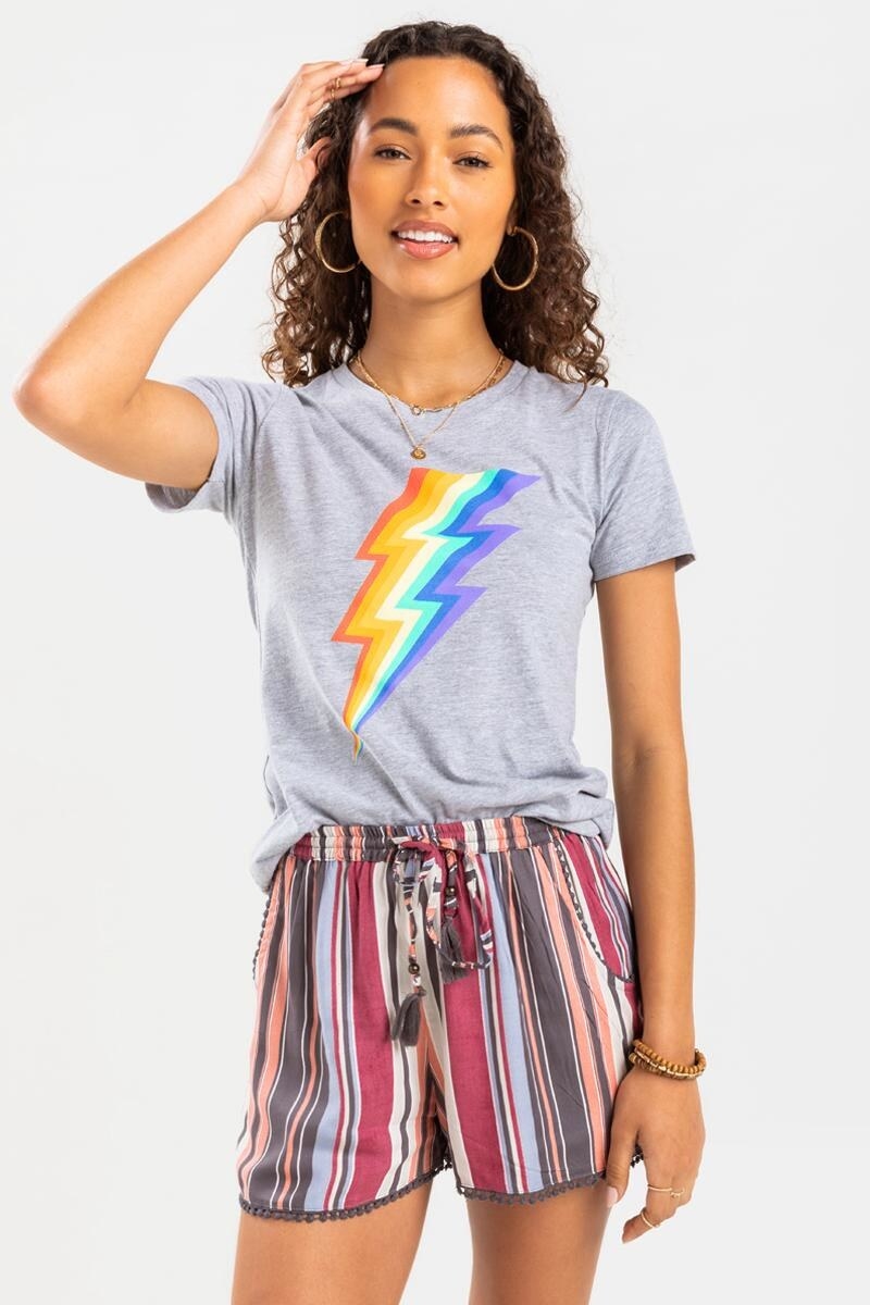 model wearing a grey t-shirt with rainbow lightning bolt on the front