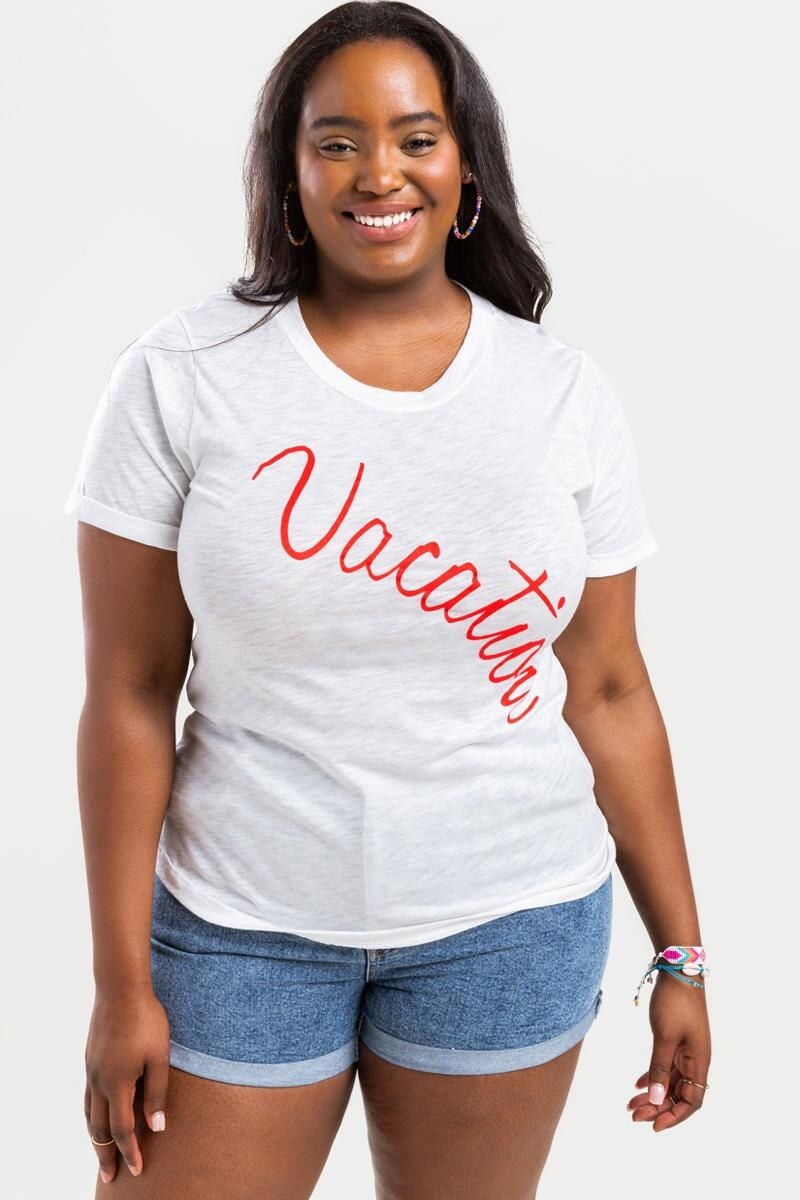 model wearing white t-shirt with red &quot;vacation&quot; written on front