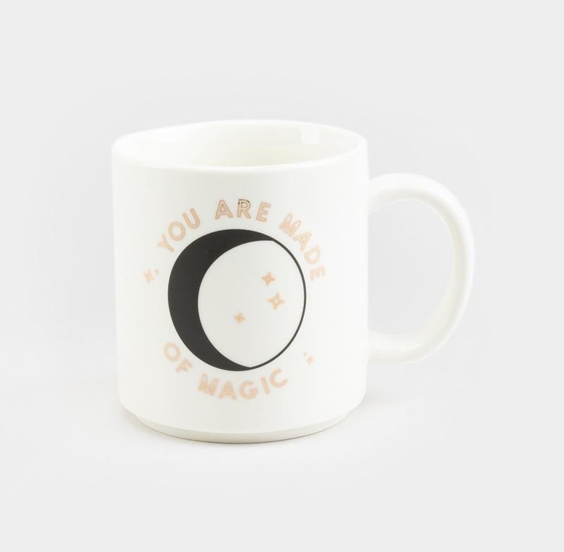 white mug with &quot;you are made of magic&quot; and a moon on the front