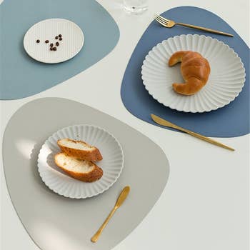 three placemats with small plates of food on each one 