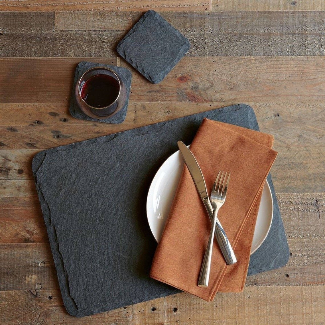 Gray rough slate placemats on a wooden table
