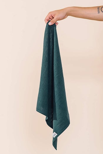 Hand holding up one of the linen napkins 