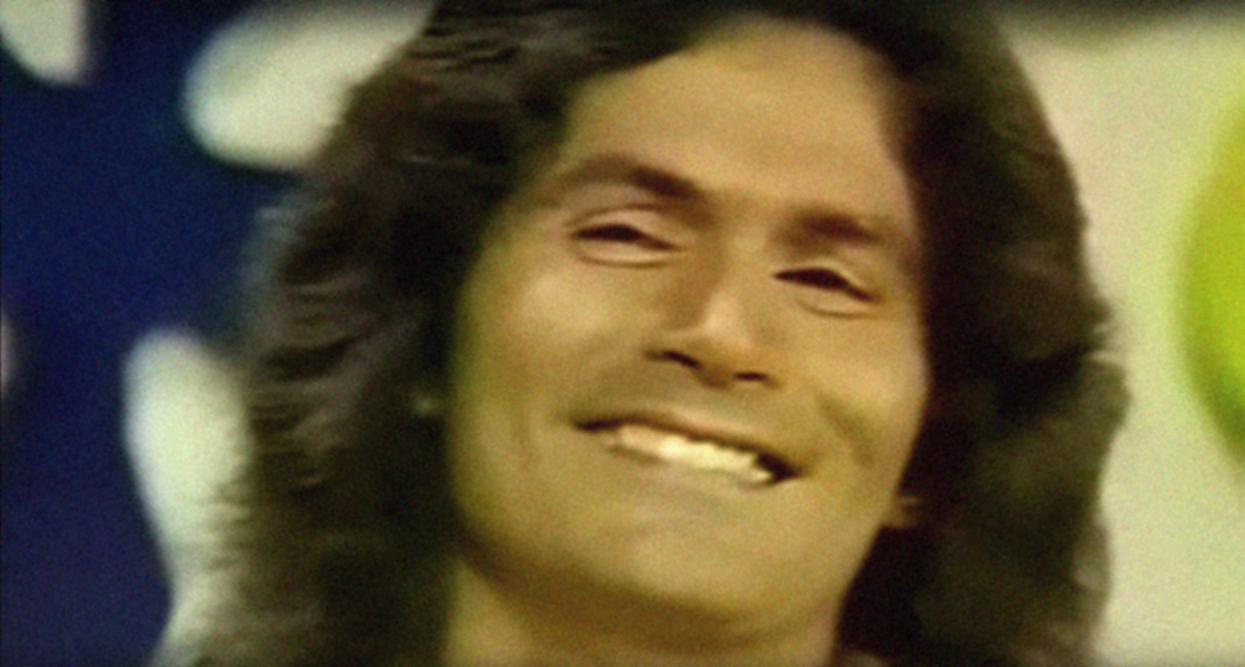 Rodney Alcala grinning after being asked a question on The Dating Game