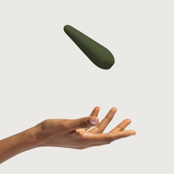 Model with green minimalist vibrator in motion
