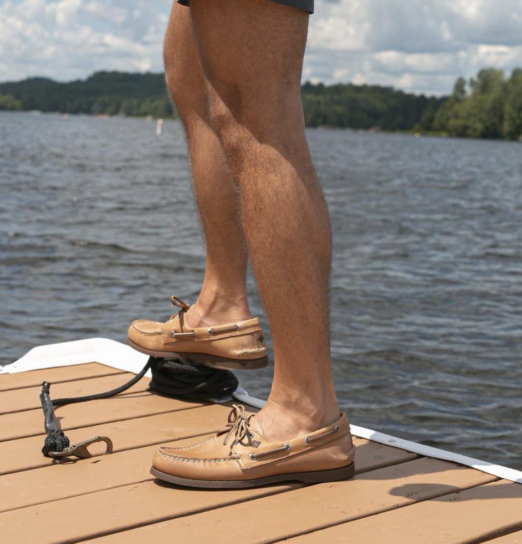 person on a dock with the shoes on