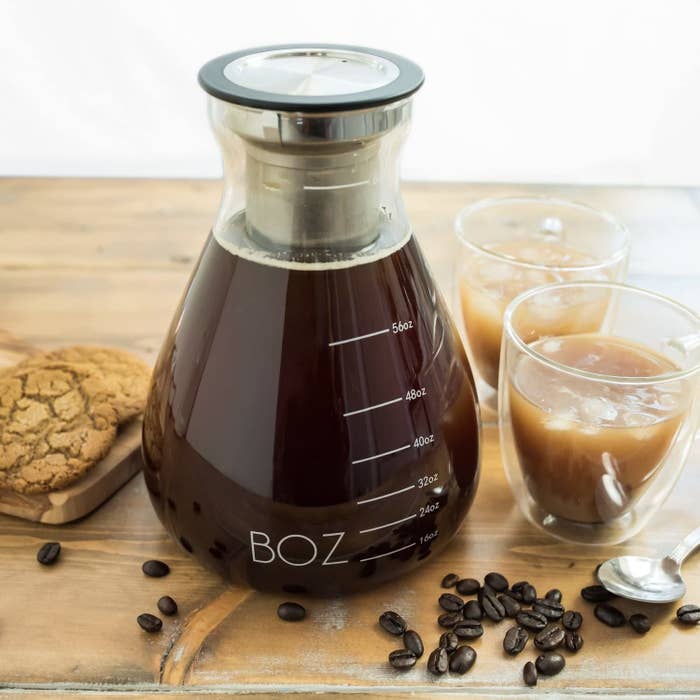 a pitcher of iced coffee on a cutting board