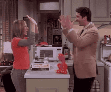 Jennifer Aniston and David Schwimmer high-five in a scene from &quot;Friends&quot;