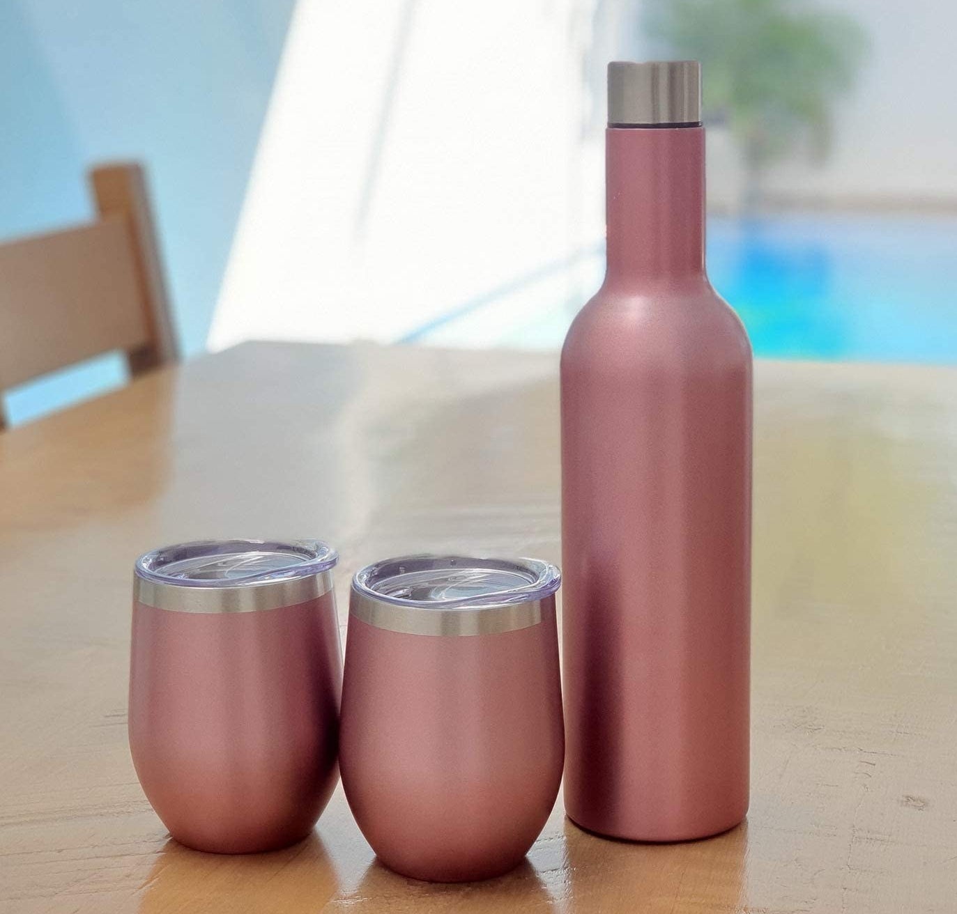 two tumblers next to an insulated bottle