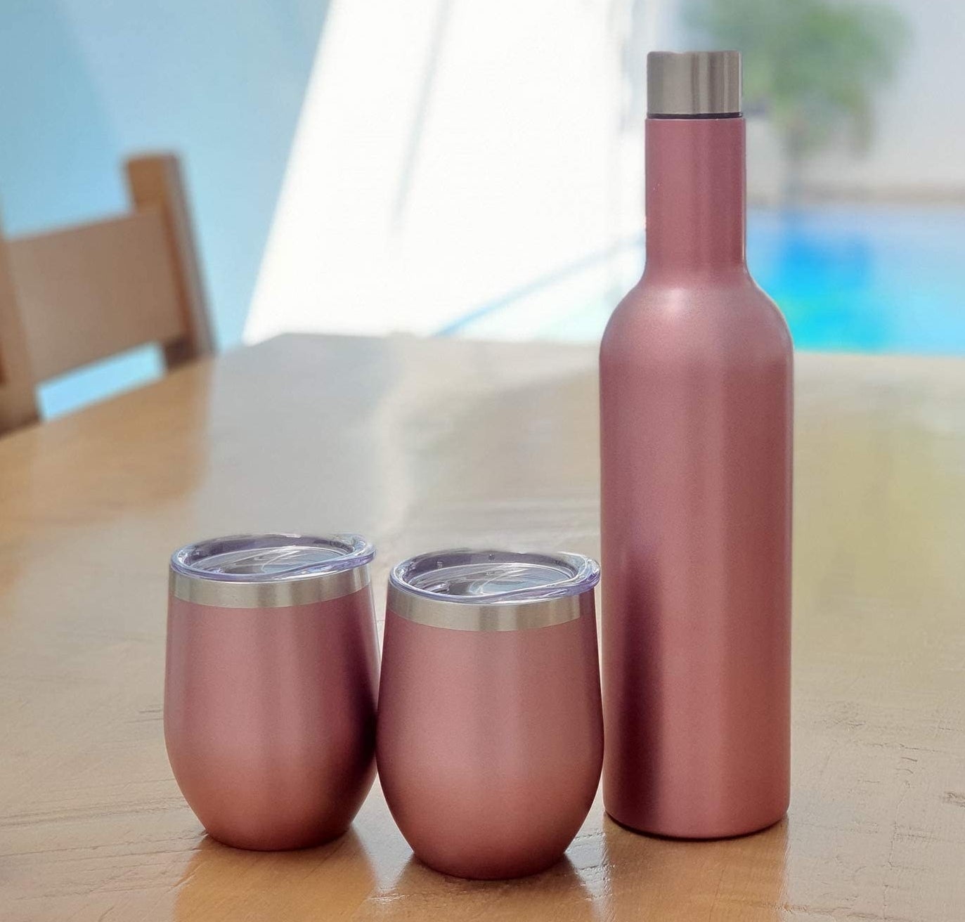 two tumblers next to an insulated bottle