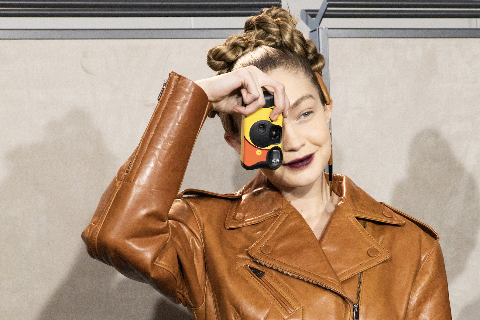 Top model Gigi Hadid with her single-use camera is seen backstage at the Fendi fashion show on February 20, 2020, in Milan, Italy