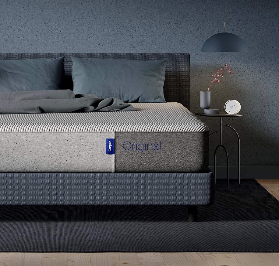 A Casper Sleep memory foam mattress on gray bed platform