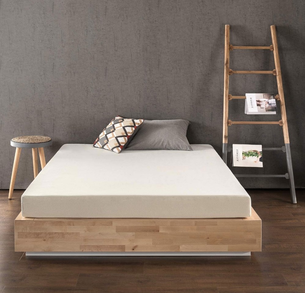 the cream colored mattress on a wooden bed platform