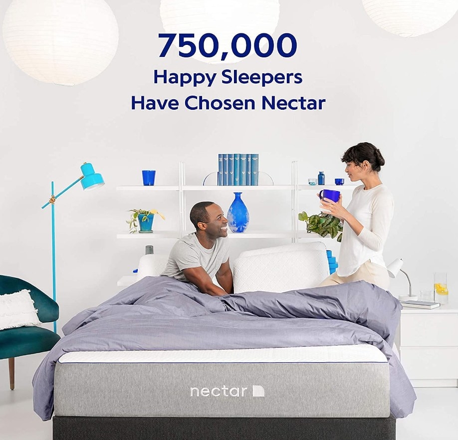 Models sleeping on a memory foam mattress that comes with two free pillows