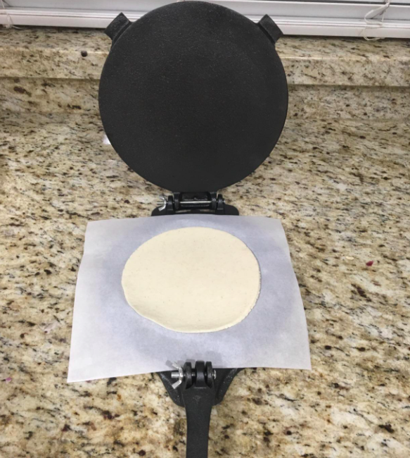 A customer review photo of the tortilla press being used on their counter
