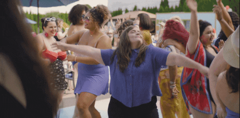 Aidy Bryant dancing at a pool and letting loose