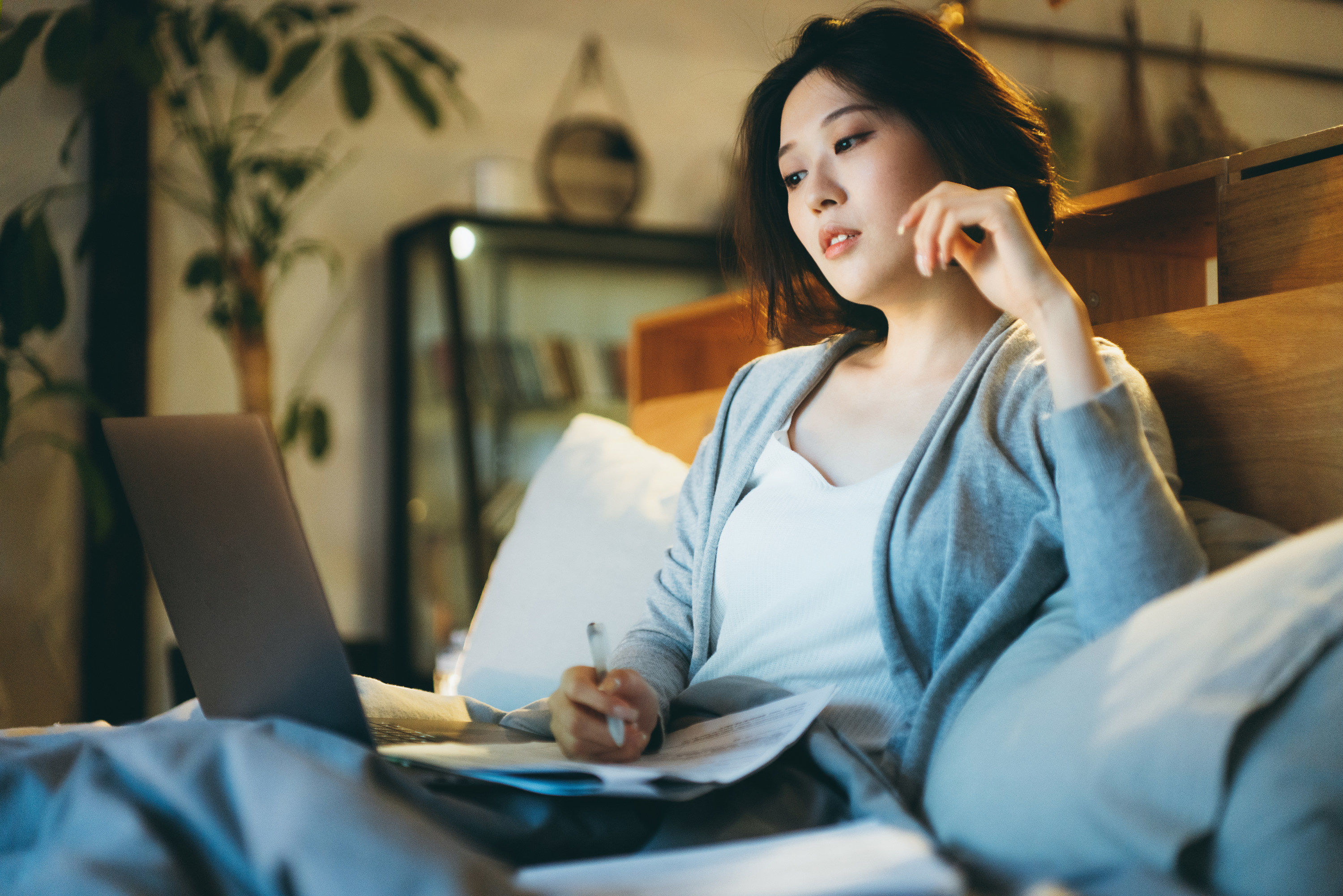 Young woman looking at stocks on her laptop