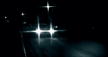 A car with exaggerated diamond-shaped headlights approaching