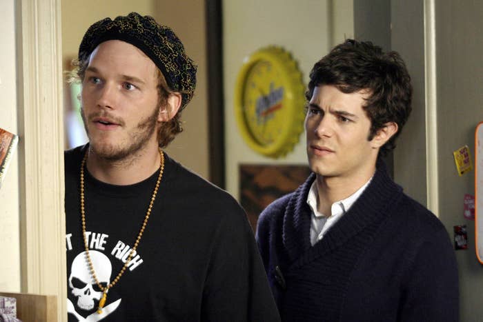 Chris Pratt, in a beanie and skull-and-bones t-shirt, stands next to Brody who&#x27;s wearing an ascot and a collered shirt