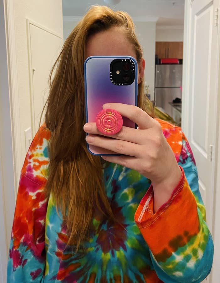 Rebecca Norris holding her Casetify Case with a PopSocket PopGrip attached.