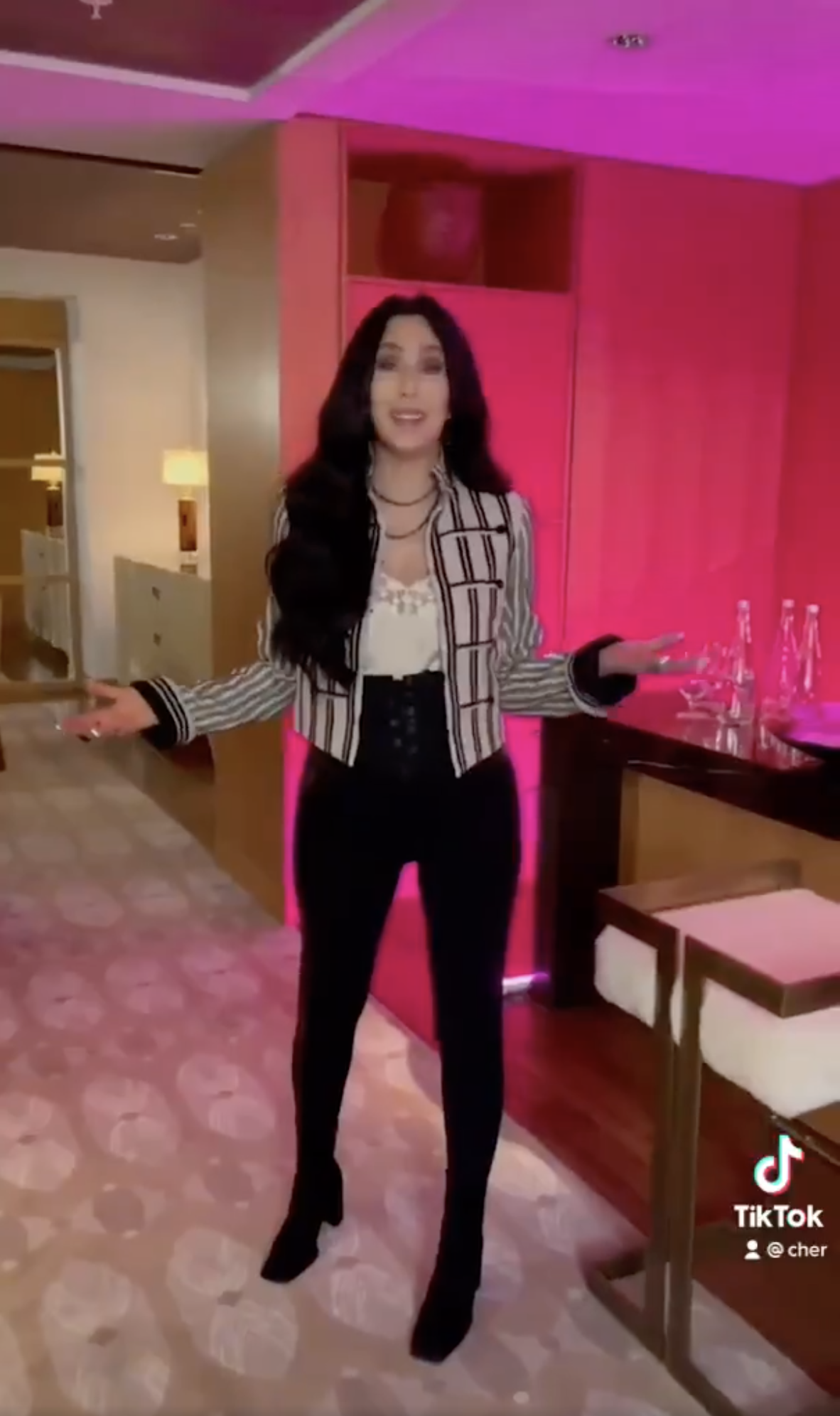 Cher again appears as a brunette in her first TikTok video