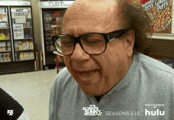 Frank from Always Sunny in a good store chewing and licking his lips with eyes closed