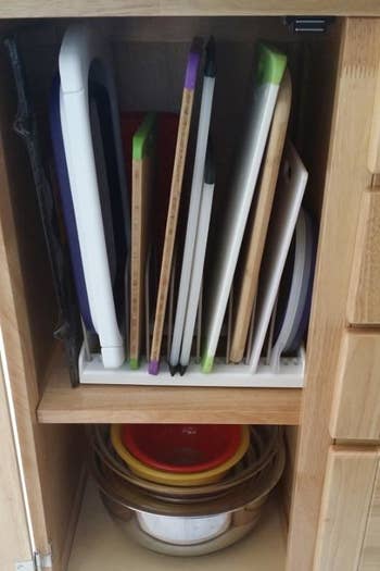 Reviewer showing all their cutting boards stored upright in a slim cabinet