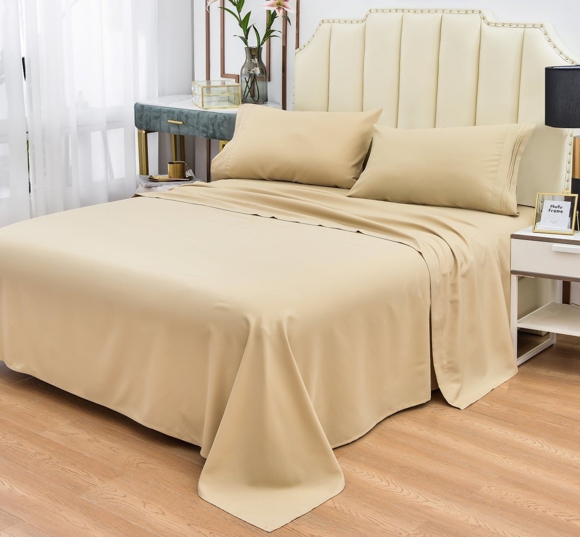 Tan bedsheets on bed