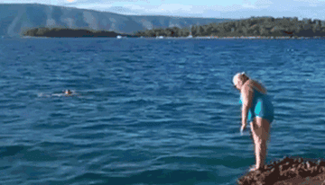 A home video of a woman jumping into a body of water