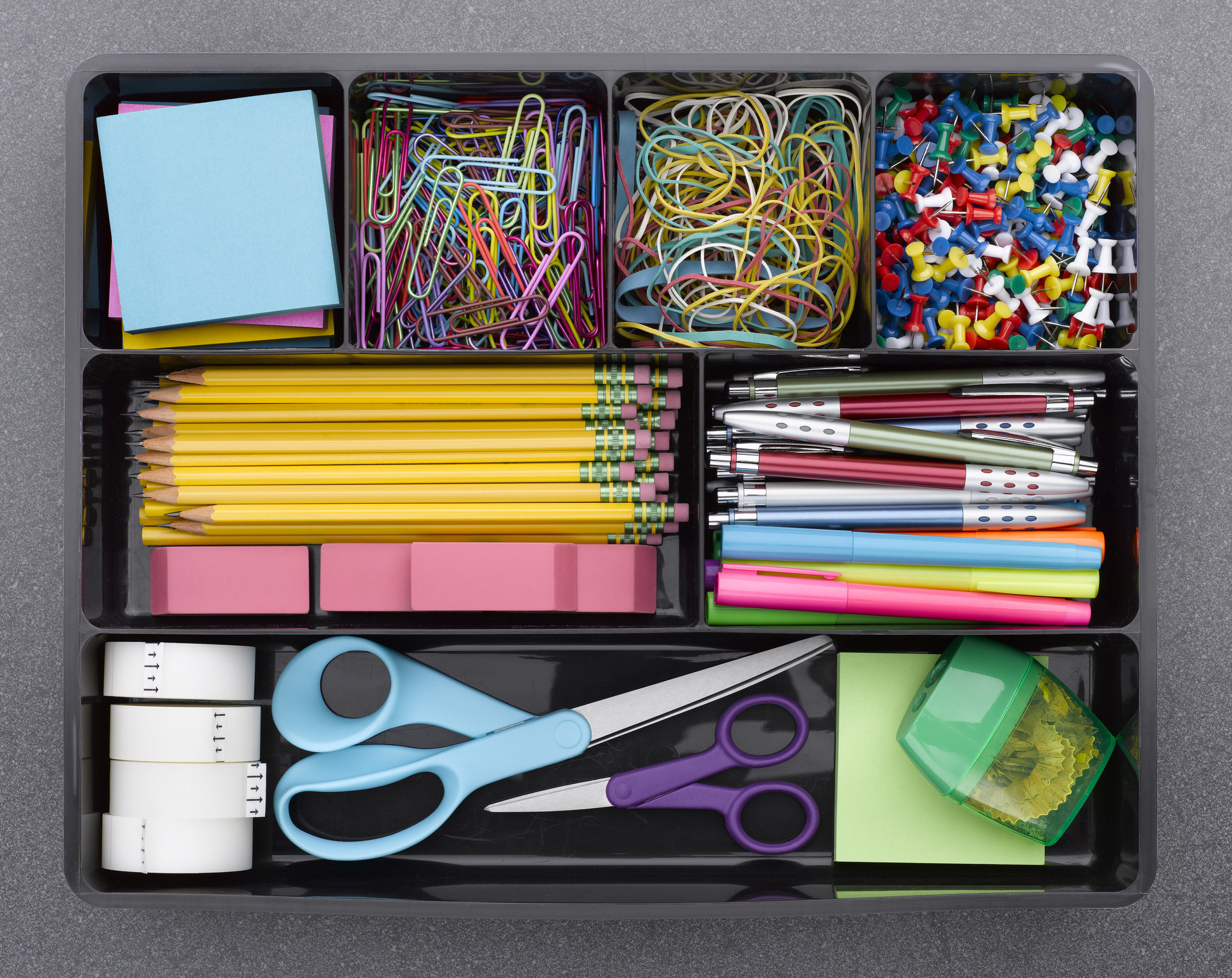 Very organized office supplies in different sections