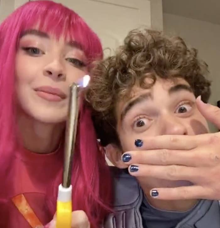 Joshua and Sabrina wear Shark boy and Lava girl costumes while making a TikTok