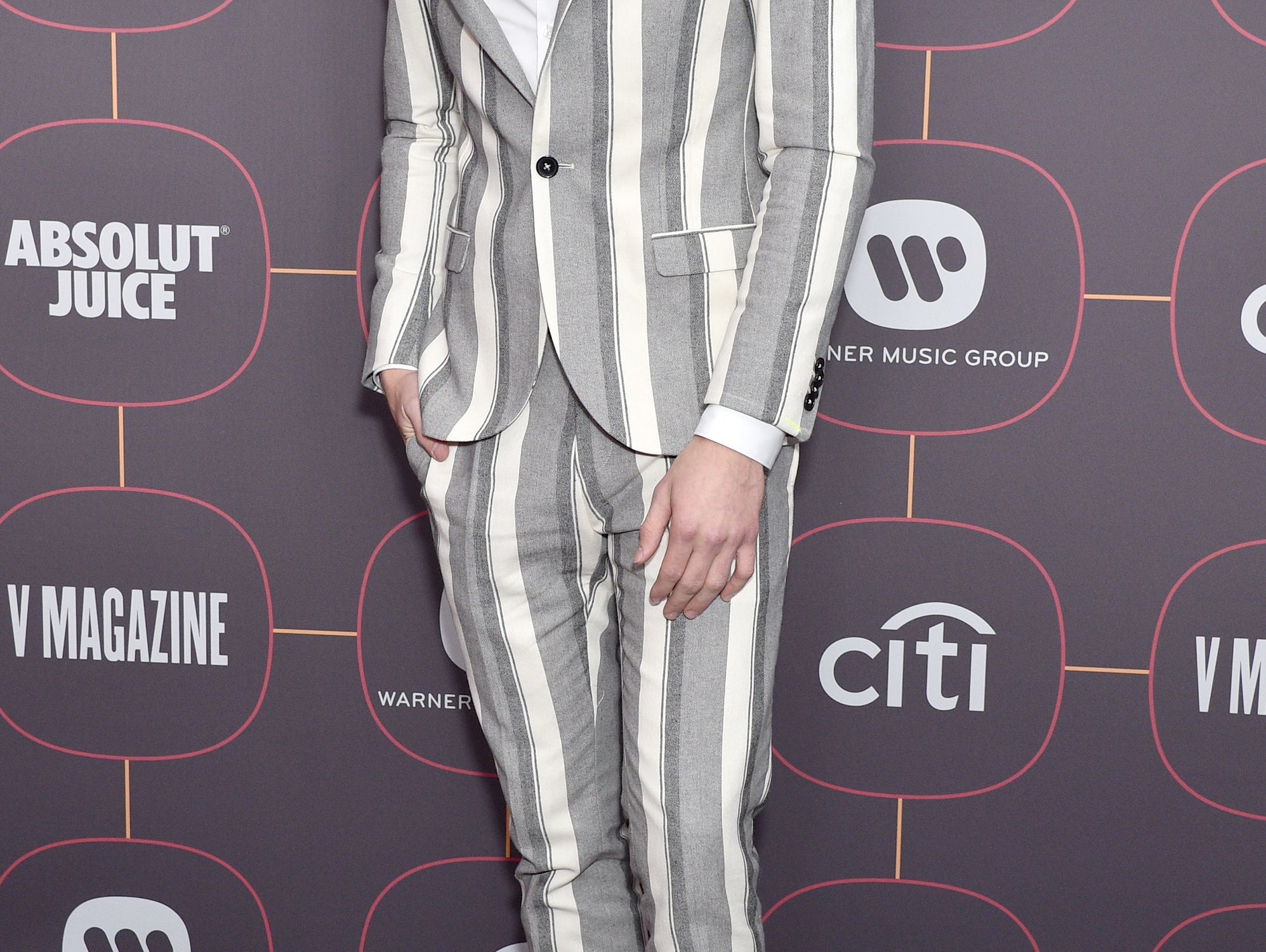 Joshua wears a striped blazer at an event