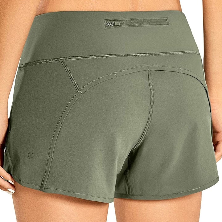 a person wearing the exercise shorts from the back, showing us the zip-up pocket 