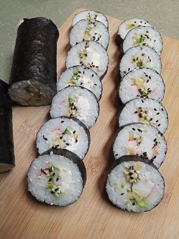 a reviewer photo of the sushi roll and sushi rolls cut