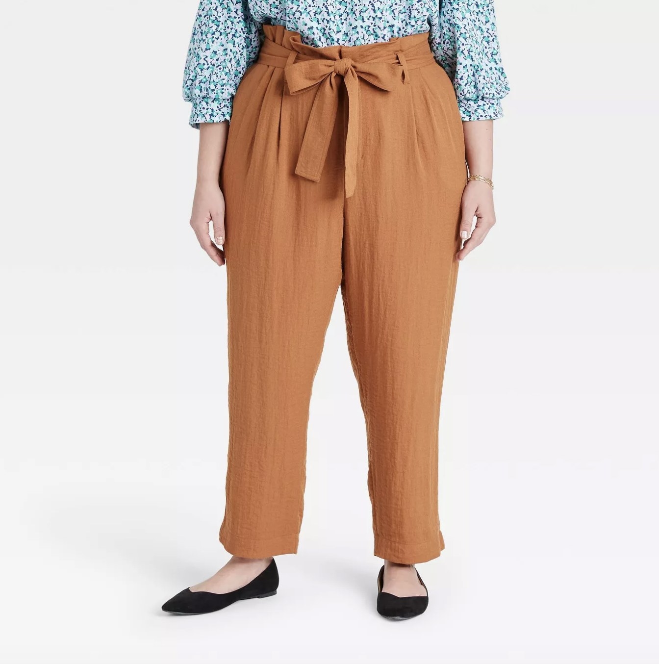 a model wearing the pants in brown