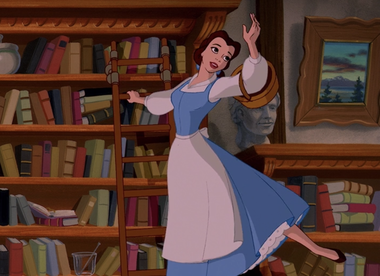 Belle stands on a ladder near book shelves