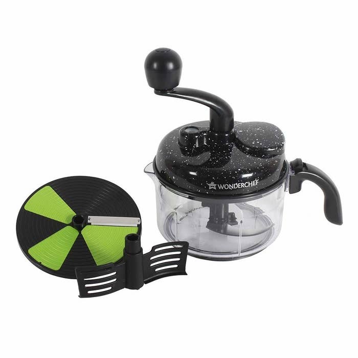 The manual food processor pictured with its slicing and chopping blades and kneading attachment