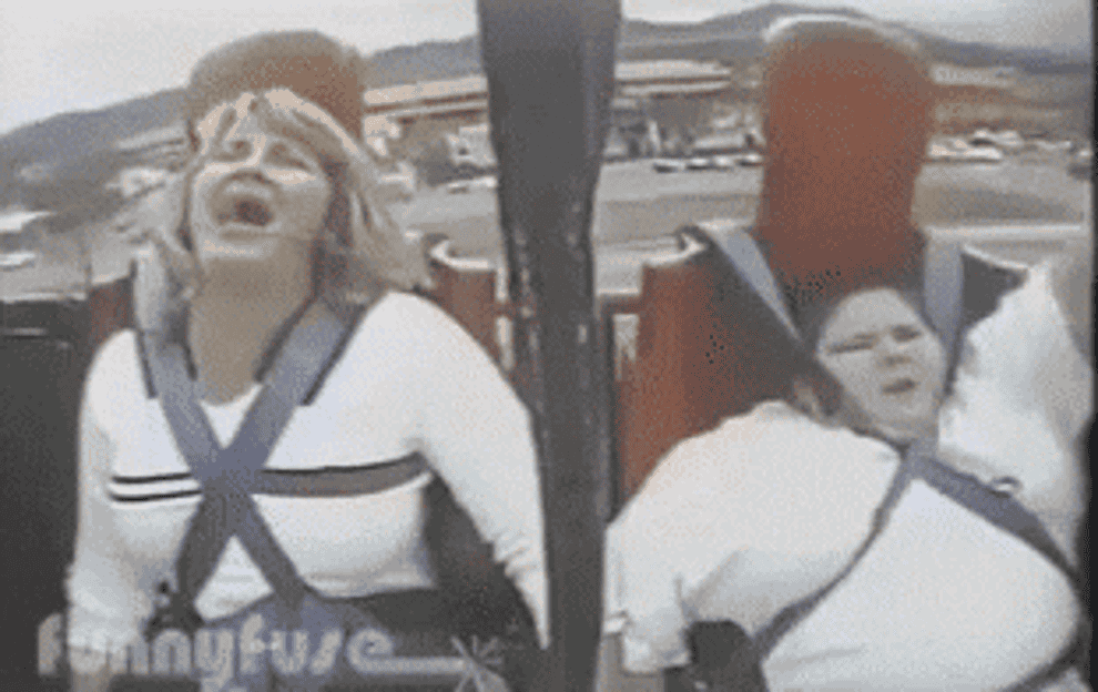 Two people screaming on a roller coaster