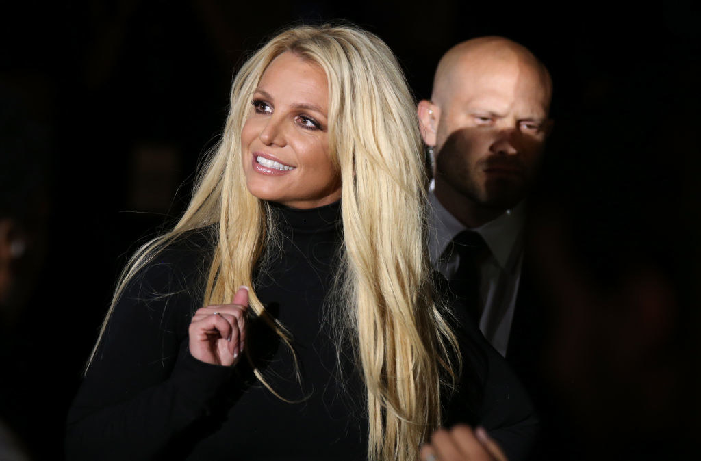 Britney Spears smiles while gazing toward a point off camera