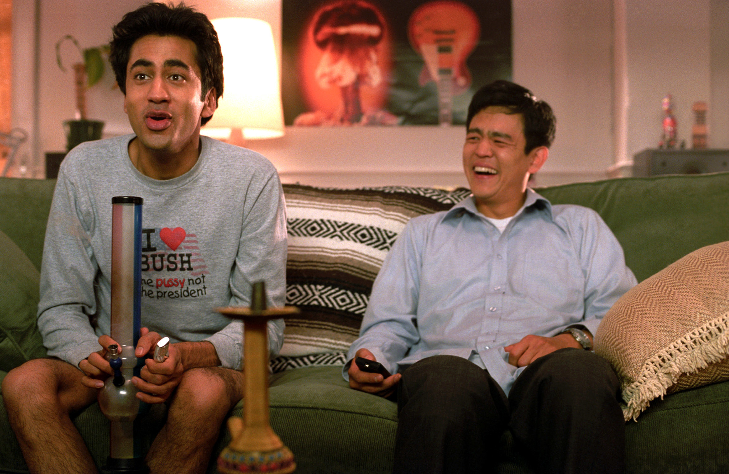 Harold and Kumar smoking on the couch
