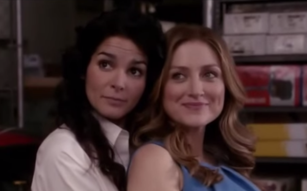 Jane Rizzoli holds Maura Isles from behind as they both smile